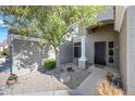 Inviting front entrance with a decorative door, shaded porch, and desert landscaping at 104 W Windsong Dr, Phoenix, AZ 85045