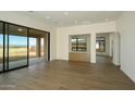 Bright living room boasting hardwood floors, sliding glass doors, and outdoor views at 12870 E Rosewood Dr, Scottsdale, AZ 85255