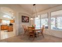 Inviting dining area with a round wooden table, bright window, and access to the kitchen at 1310 S Vine Ct, Gilbert, AZ 85233