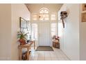 Bright foyer with a high ceiling, white tile floors, and decorative accents creates a welcoming entrance at 1310 S Vine Ct, Gilbert, AZ 85233