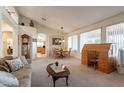 Spacious living room featuring a large window, comfortable seating, and a dining area at 1310 S Vine Ct, Gilbert, AZ 85233