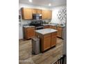 Well-lit kitchen features stainless steel appliances, wooden cabinets, and granite countertops at 13820 S 41St Way, Phoenix, AZ 85044
