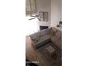 Sun-filled living room features a fireplace, vaulted ceilings, and a cozy sectional couch at 13820 S 41St Way, Phoenix, AZ 85044
