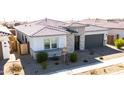 Aerial view of single-story home showing nice roof, desert landscaping, and two-car garage at 14177 W Calle Lejos --, Surprise, AZ 85387