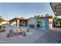 An outdoor fire pit, a BBQ, and sliding glass doors define this private backyard entertainment space at 2106 W Shawnee Dr, Chandler, AZ 85224