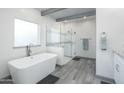 Modern bathroom featuring a freestanding tub, glass-enclosed shower, and stylish tile accents at 2106 W Shawnee Dr, Chandler, AZ 85224