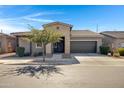 Welcoming single-story home with a two-car garage, desert landscaping, and a well-kept front yard at 22443 E Munoz St, Queen Creek, AZ 85142