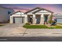Beautiful single-story home with manicured lawn, columns, and a gray garage door at 2260 E Warbler Rd, Gilbert, AZ 85297
