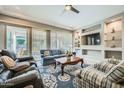 Cozy living room with built-in shelves, television, and sliding glass doors at 25925 W Mcrae Dr, Buckeye, AZ 85396