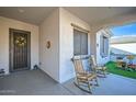 Inviting porch with rocking chairs and a view of the artificial turf area at 25925 W Mcrae Dr, Buckeye, AZ 85396