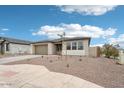 Charming single-story home with a well-manicured desert landscape and paved driveway at 26361 N 76Th Dr, Peoria, AZ 85383