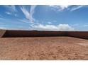 Spacious lot ready for personalization, enclosed by a block wall at 36805 W San Clemente St, Maricopa, AZ 85138
