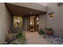 Exterior view of the home's front entrance showcasing a tiled walkway and desert landscaping at 38951 N 101St Way, Scottsdale, AZ 85262