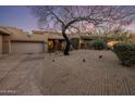 Exterior view of a single story home featuring desert landscaping and a winding driveway at 38951 N 101St Way, Scottsdale, AZ 85262