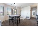 Bright dining area featuring a chandelier, neutral carpet, and large windows at 5450 E Mclellan Rd # 133, Mesa, AZ 85205