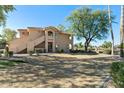 Exterior view of two-story condo featuring desert landscaping and proximity to a greenbelt at 5450 E Mclellan Rd # 133, Mesa, AZ 85205