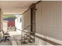 Inviting covered porch with steps leading to the entrance of the manufactured home at 5601 W Missouri Ave # 2, Glendale, AZ 85301