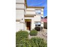 Charming front exterior with desert landscaping, showing the front door and American flag at 5608 E Lush Vista Vw, Florence, AZ 85132