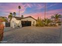 Charming home with a well-manicured desert landscape, two car garage, and inviting curb appeal at 5916 E Hearn Rd, Scottsdale, AZ 85254