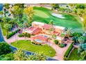 Luxury home featuring a terracotta roof, a pool, and a lush green lawn situated on a golf course at 7155 E Oakmont Dr, Paradise Valley, AZ 85253