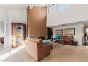 Inviting living room with vaulted ceilings, large windows, and a cozy seating area at 9709 E Mountain View Rd # 2703, Scottsdale, AZ 85258