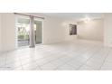 Spacious living area with tiled flooring, a large sliding glass door and natural light at 100 W Maryland Ave # H1, Phoenix, AZ 85013