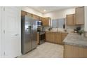 Inviting kitchen featuring stainless steel appliances, light wood cabinets, and abundant counter space at 14000 N 94Th St # 3159, Scottsdale, AZ 85260