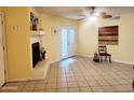 Spacious living room features a fireplace and neutral tile flooring, offering a versatile living space at 16402 N 31St St # 134, Phoenix, AZ 85032