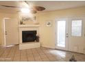 Bright living room featuring a fireplace, ceiling fan, and tile floors, perfect for relaxing or entertaining guests at 16402 N 31St St # 134, Phoenix, AZ 85032