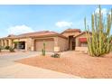 Lovely single-Gathering home with two-car garage, red tile roof, desert landscaping, and attractive paint at 18080 W Udall Dr, Surprise, AZ 85374