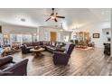 Spacious living room with hardwood floors, leather furniture, and lots of natural light at 20006 W Highland Ave, Litchfield Park, AZ 85340