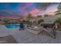 Inviting backyard featuring a spa, fire pit, and comfortable seating, perfect for outdoor gatherings at 20618 W Western Dr, Buckeye, AZ 85396