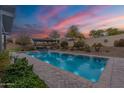 Stunning backyard pool with a covered lounge area offering a relaxing oasis for entertaining at 20618 W Western Dr, Buckeye, AZ 85396
