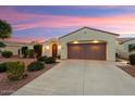 Well-maintained home boasting desert landscaping, an arched entryway, and a two-car garage at 22416 N Arrellaga Dr, Sun City West, AZ 85375