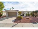 Charming single-story home with manicured landscaping and a two-car garage on a sunny day at 22515 N Arrellaga Dr, Sun City West, AZ 85375
