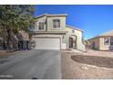 Beautiful two-story home featuring desert landscaping with a brick border, a covered entryway, and a two-car garage at 2325 S 88Th Dr, Tolleson, AZ 85353