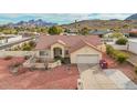 An aerial view of a charming single-story home with a tile roof and desert landscaping, complemented by mountain views at 2365 E Shea Blvd, Phoenix, AZ 85028