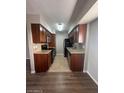 Functional kitchen featuring dark wood cabinets, granite countertops and stainless steel appliances at 2625 E Indian School Rd # 335, Phoenix, AZ 85016