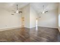 Open-concept floor plan with vaulted ceilings, ceiling fans, and adjacent room views at 3632 W Kelton Ln, Phoenix, AZ 85053