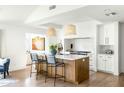 Stylish kitchen with a large island, pendant lighting, stainless steel appliances, and white countertops at 3640 E Fairmount Ave, Phoenix, AZ 85018