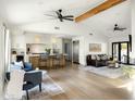 Bright open-concept living area with vaulted ceilings, modern lighting, and hardwood floors leading to the kitchen at 3640 E Fairmount Ave, Phoenix, AZ 85018