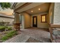 Inviting covered front porch features stone pillars and brick pavers at 4064 E Morrison Ranch Pkwy, Gilbert, AZ 85296