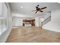 Bright, open living room featuring wood floors and a staircase at 4064 E Morrison Ranch Pkwy, Gilbert, AZ 85296