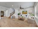 Bright living room features hardwood floors, neutral decor, and a staircase leading to the second floor at 4064 E Morrison Ranch Pkwy, Gilbert, AZ 85296