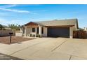 Well-kept single-story home featuring a desert landscaped yard, a two-car garage, and a wide driveway at 5242 S Clark Dr, Tempe, AZ 85283