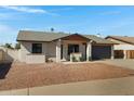 Inviting single-story home with desert landscaping and a well-maintained front yard and covered entryway at 5242 S Clark Dr, Tempe, AZ 85283