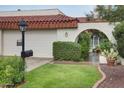 Charming home featuring a red-tiled roof, stucco walls, and a lush green lawn at 5824 N Scottsdale Rd, Paradise Valley, AZ 85253