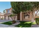 Charming two-story home with a three car garage, desert landscaping, and tiled roof details at 6931 W Antelope Dr, Peoria, AZ 85383