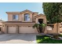 Charming two-story home with a three car garage, desert landscaping, and tiled roof details at 6931 W Antelope Dr, Peoria, AZ 85383