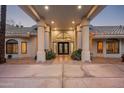 Elegant home entrance with unique double doors, tile roof, covered portico and column supports at 9128 N 70Th St, Paradise Valley, AZ 85253